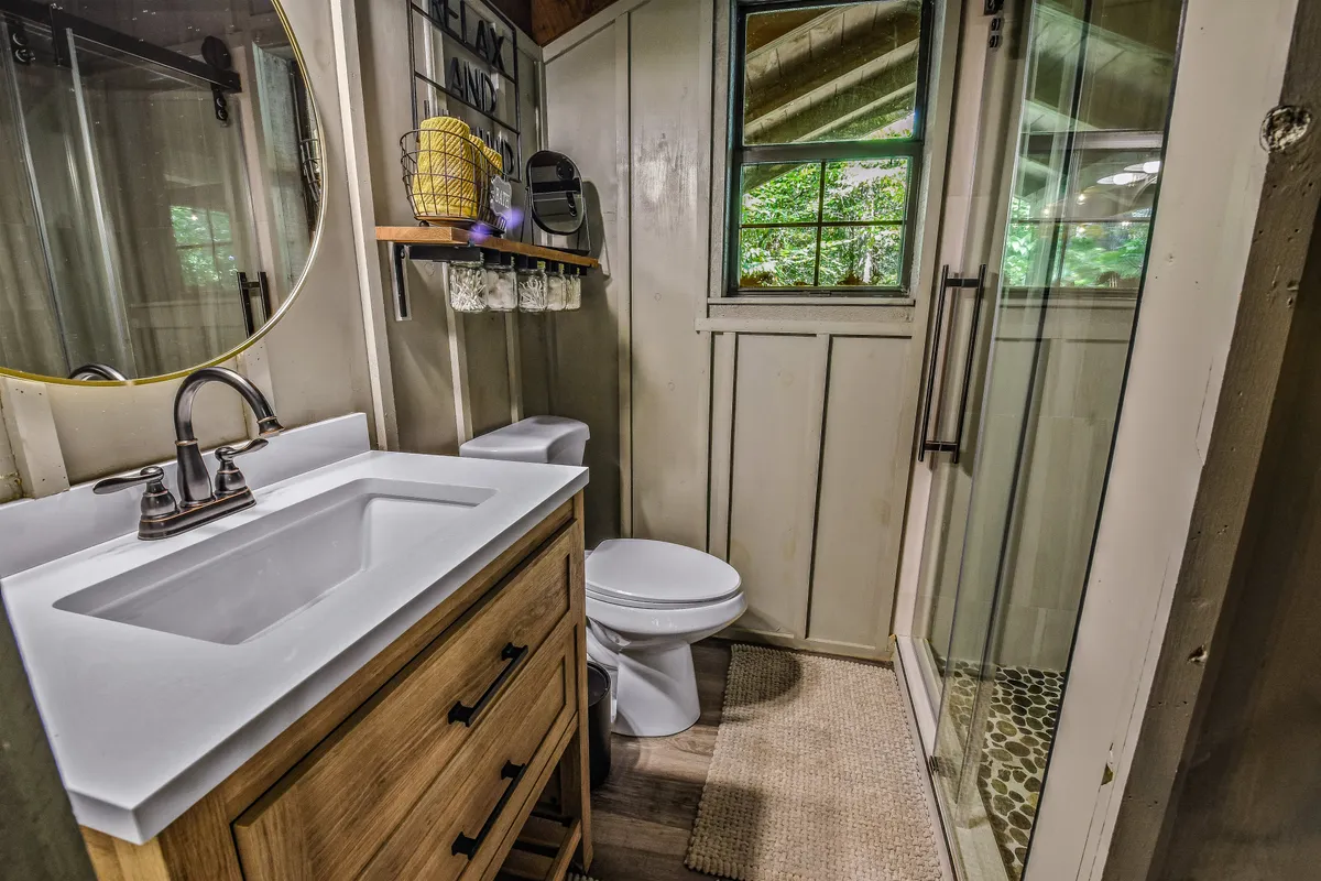 A bright, refreshing bathroom with a stylish vanity, window, and a shower area—suggesting a place to rejuvenate after a day spent hiking or exploring outdoors.